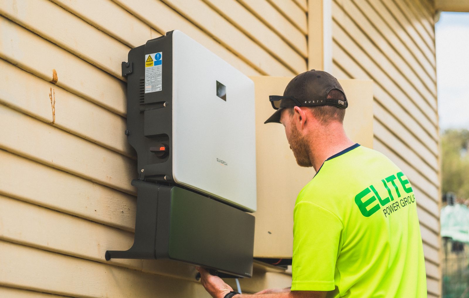 Technician commissioning a home storage inverter and battery system