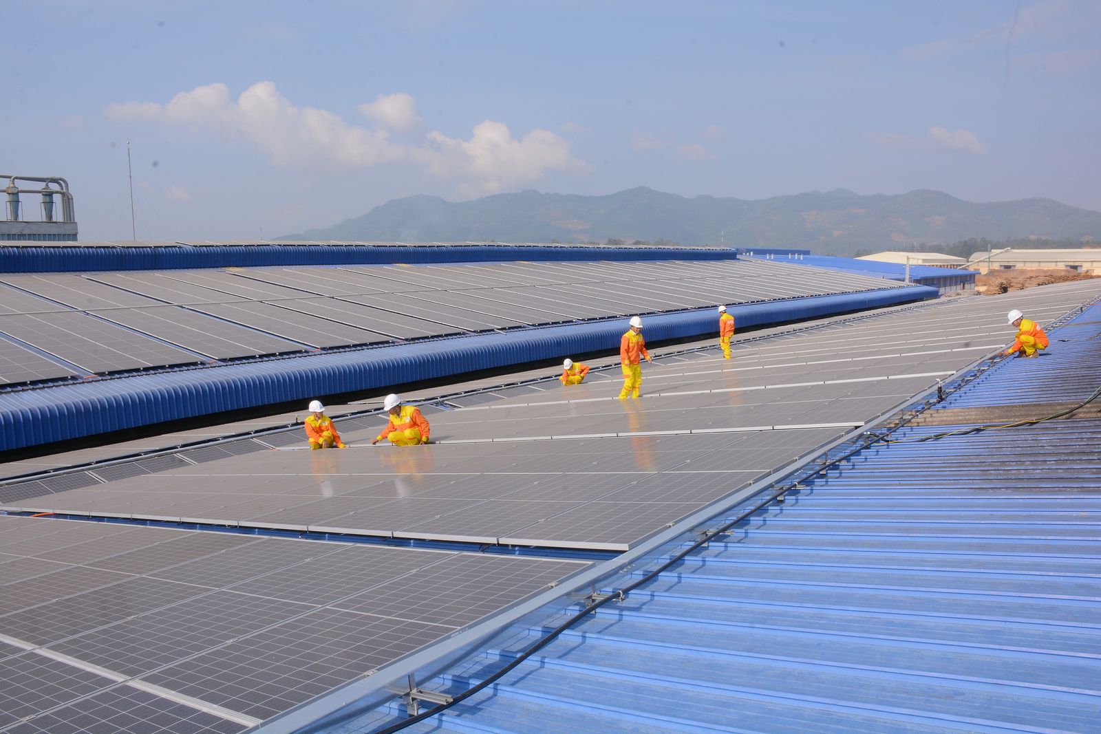Technician inspecting a completed rooftop array
